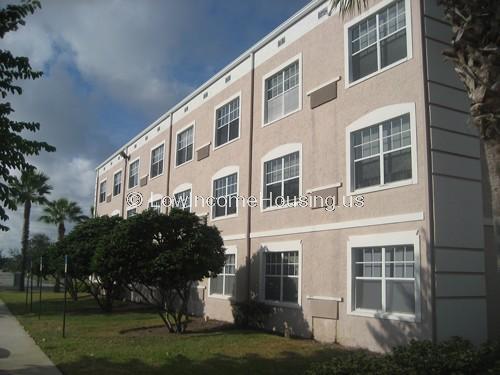 Pink brick town houses with large picture windows, built in air conditioners and security and privacy for the occupants.  