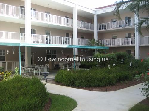 Town House living with large spacious windows, luxuriously illuminated with  white columns to create three levels of community housing.   