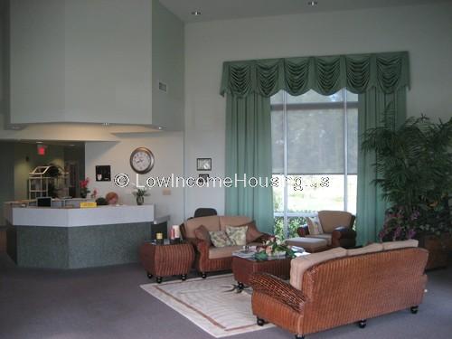 Interior view of row house with large, floor to ceiling windows. spacious room