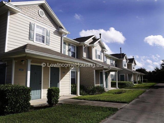 Picture of row houses with similar architectural features (four units shown in photograph).