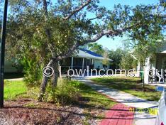 Appears to be a pathway into a housing complex.  Ample foliage in evidence