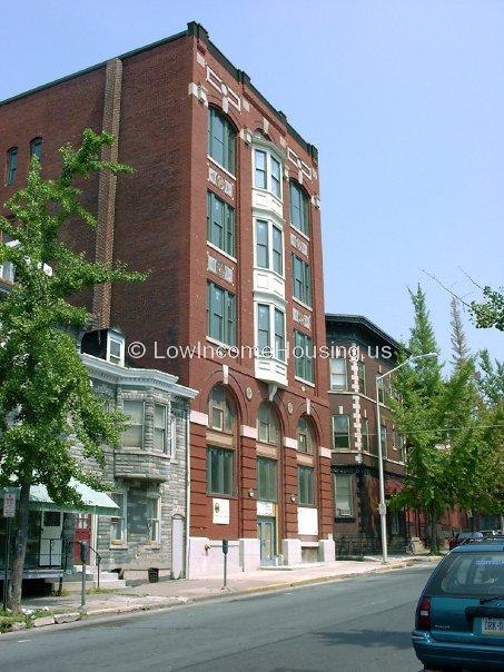 This is a photograph of a large building that has been constructed using a very large number of red bricks.  