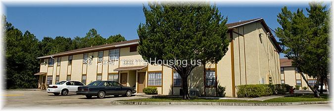 Large row house construction with single entrance located at the end of the building and Larger entrance locate in the middle of the building.  