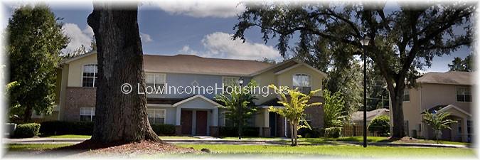 Detached row house with 3 large picture windows and2 front doors