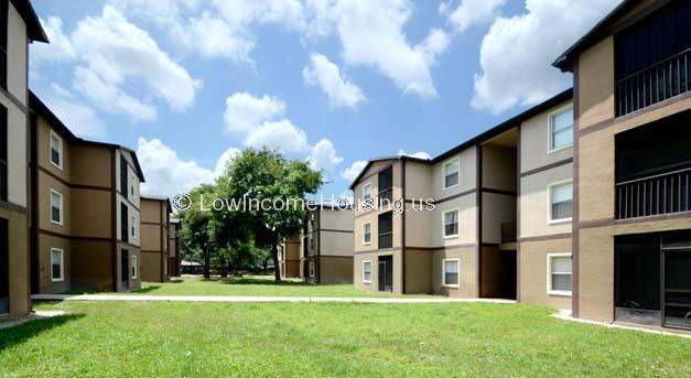 Classic brick construction for three level row housing featuring large, floor to ceiling windows.