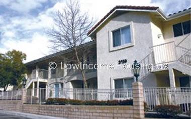 White row houses with large picture windows, exterior stair case to top floor