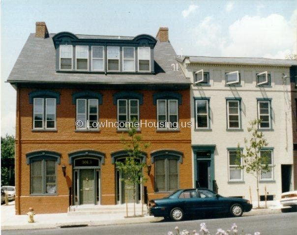 Classic red brick apartment building with four apartments per floor.  Convenient street level parking is available for all residents  