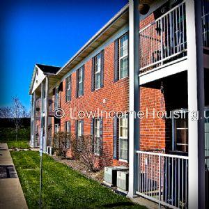 Classic Row House design with characteristic bright Red Brick, Steel Stairway access on right and left sides with wrought iron steel stairway, Four external air conditioning units.  