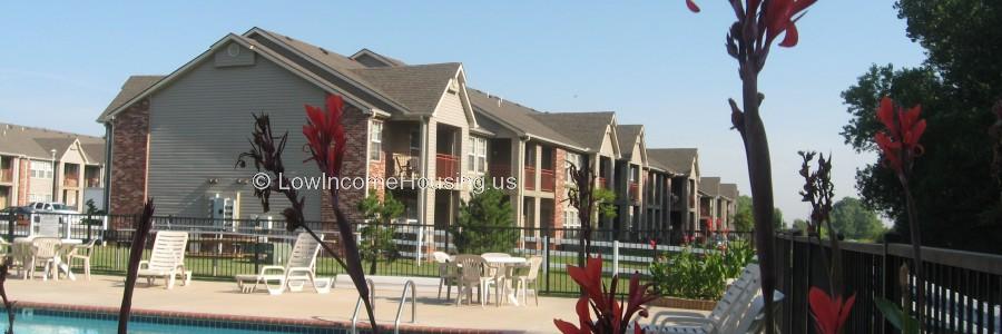 Classic Red Brick Row House design with 6 Large Dormer balconies, wrought iron railing, fenced in tables and chairs.