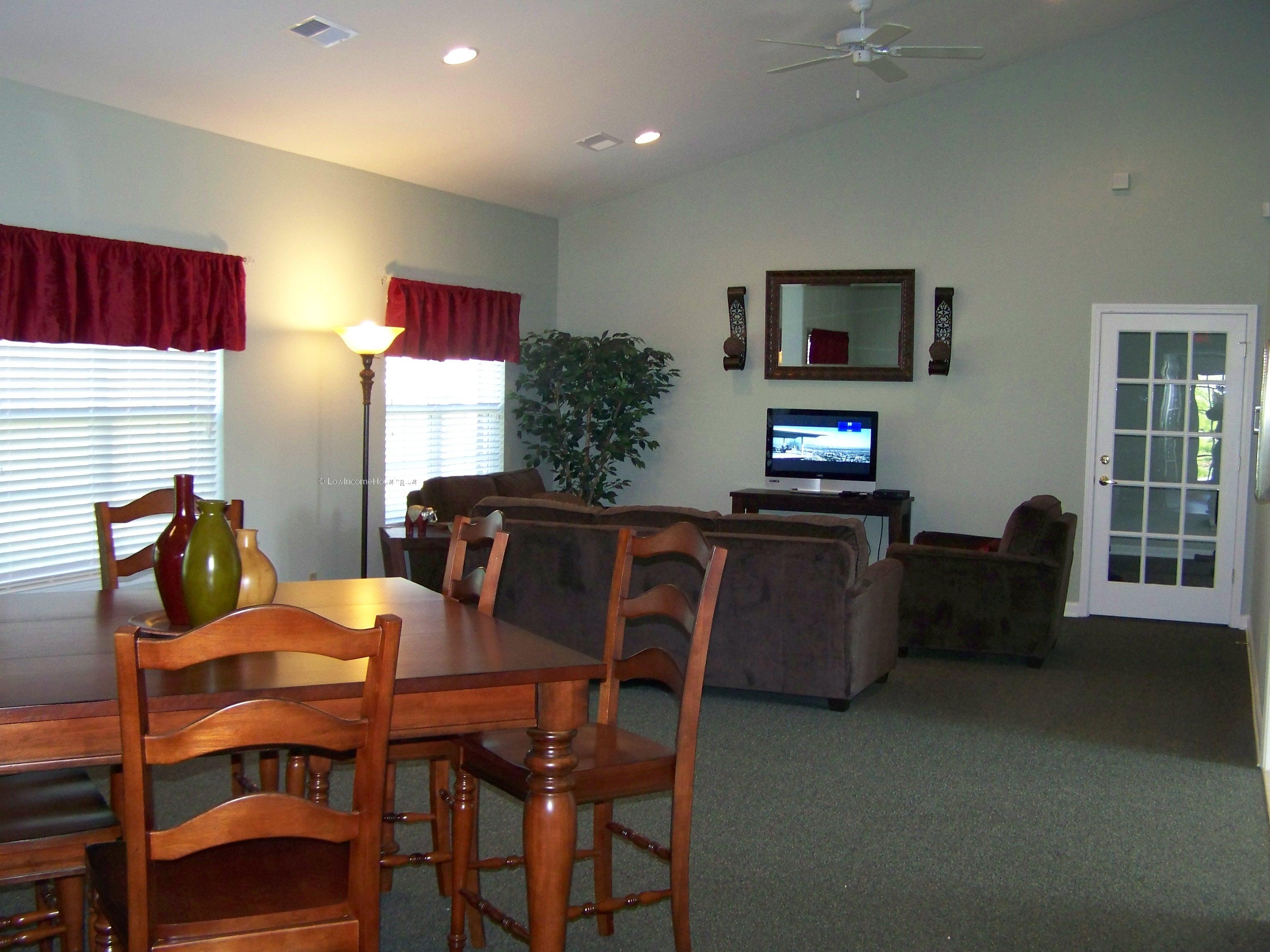 Elegant dining area with solid wood dining table and complete set of wooden chairs.