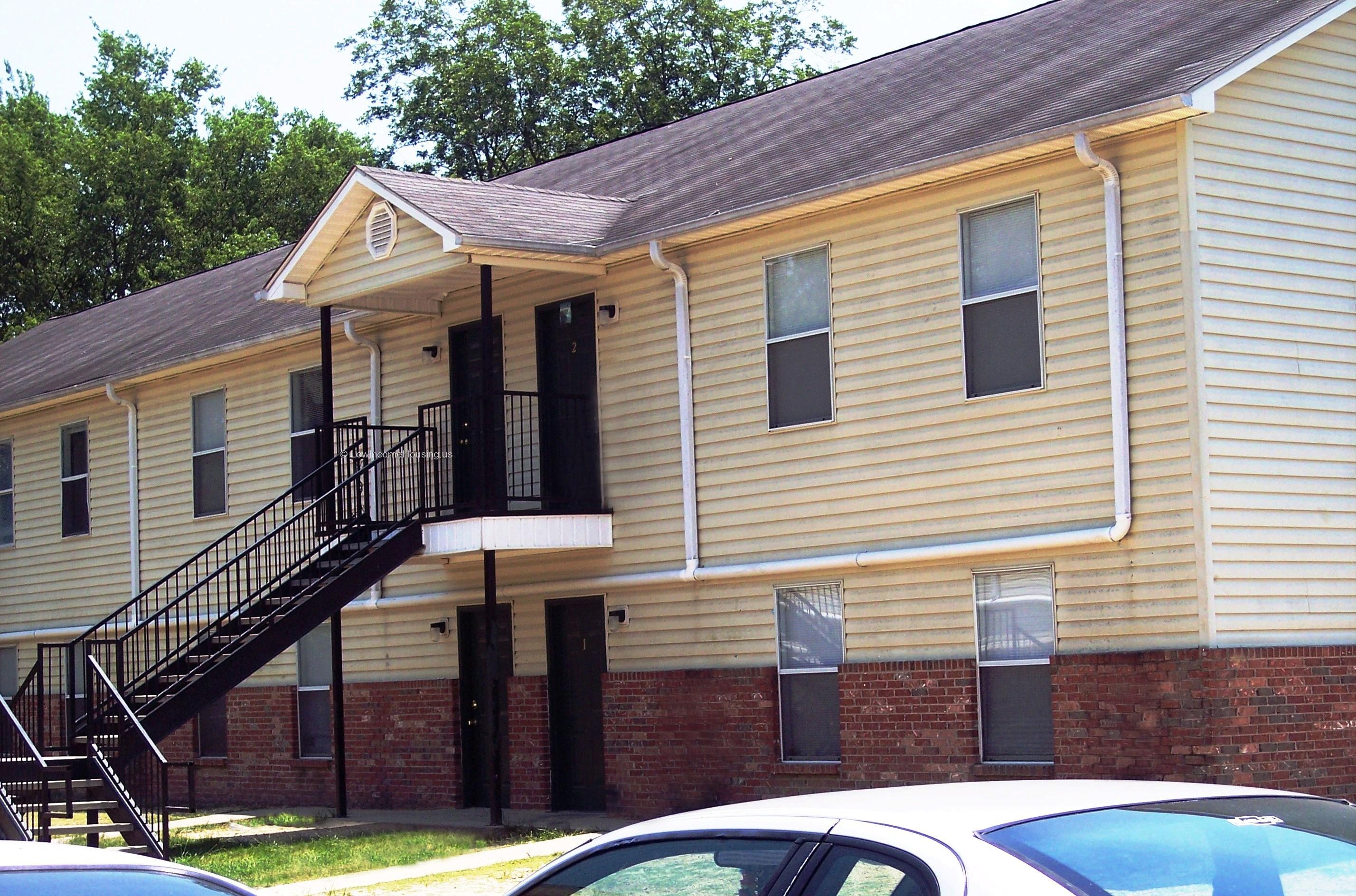 Wrought iron stairway provides access to second floor meeting room equipped with six large floor to ceiling windows. 