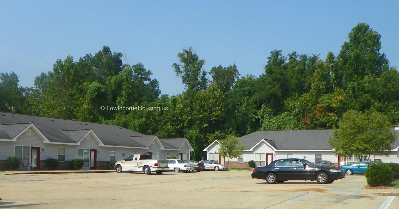 Classic red brick foundation for low income housing units with ample curb parking for residents. 