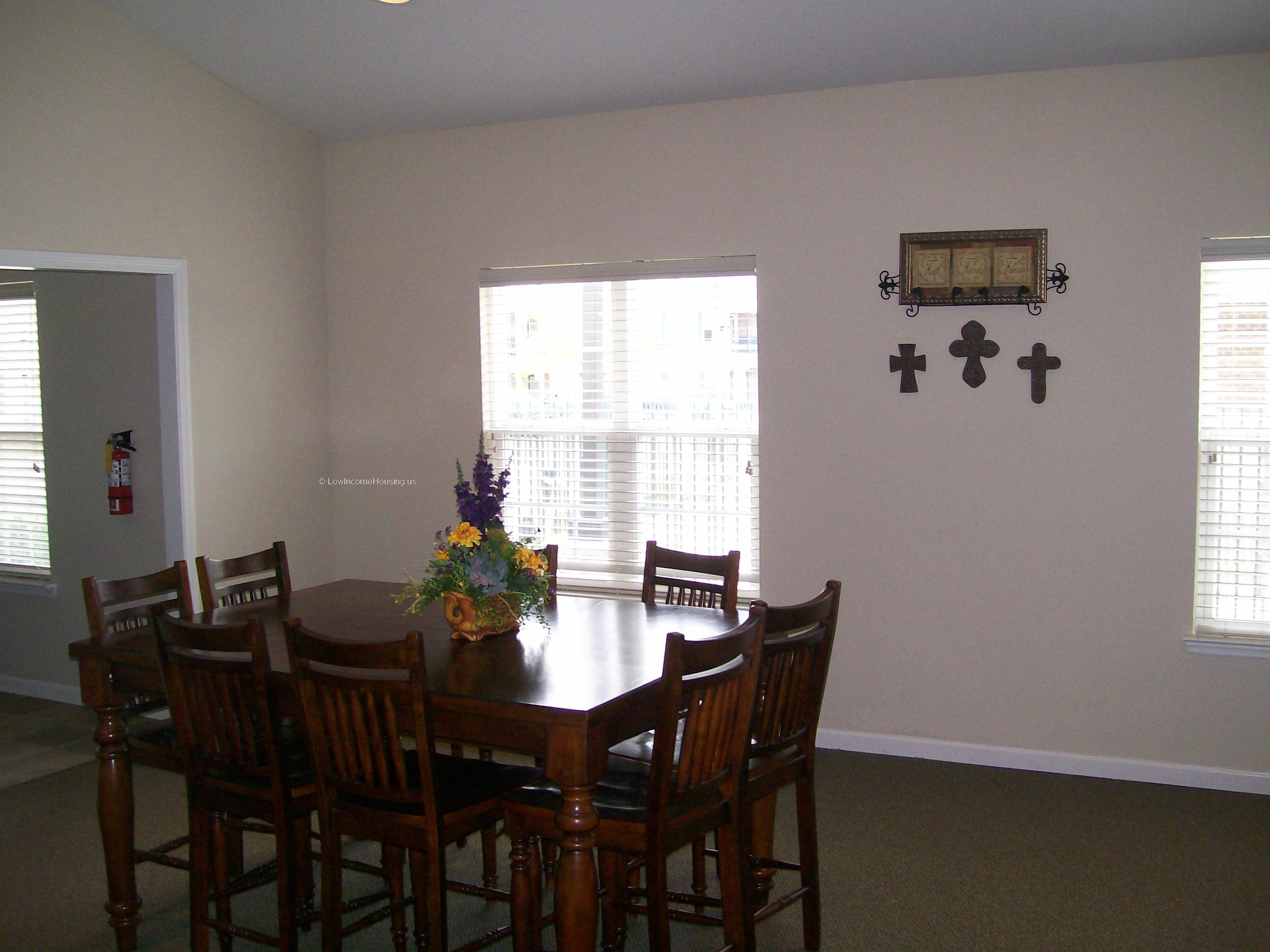 Spacious dining area with natural light and access to living room area. 