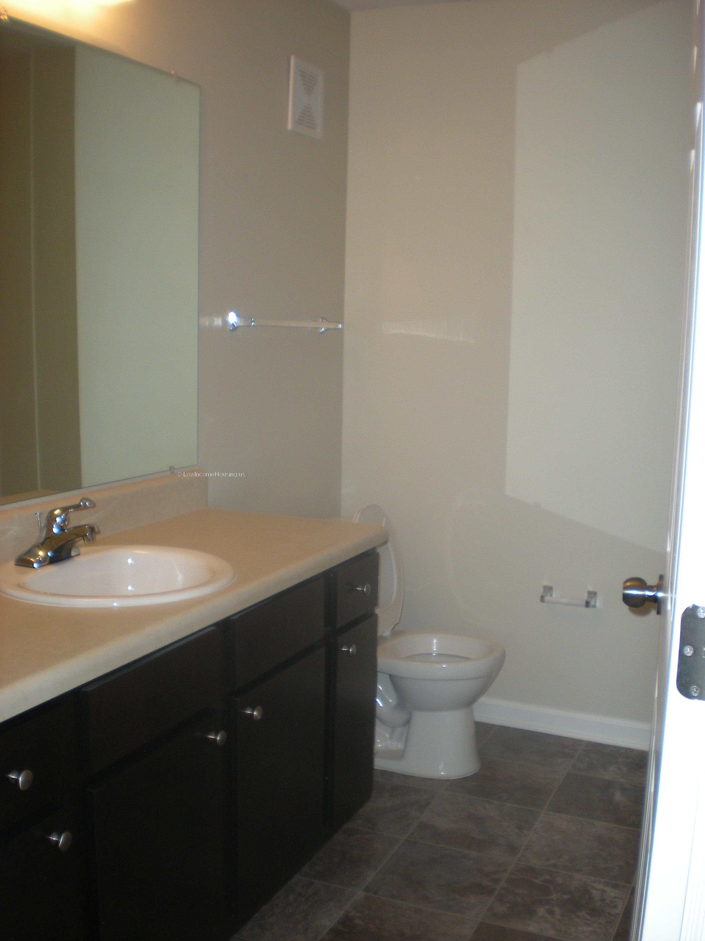 Interior of toilet facilities, sink, large mirror 