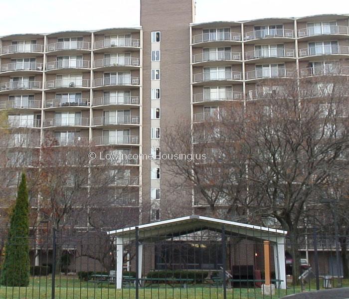 Large brick apartment complex with elevator access to all floors and balconies with wrought iron fencing 