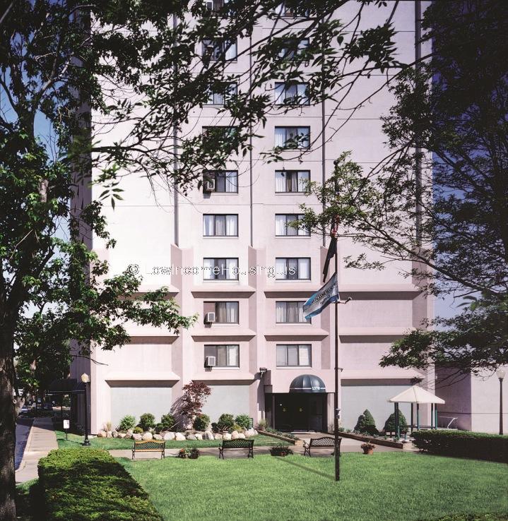 MULTI STORY LOW INCOME HOUSING with window air conditioning units Additional Windows on the left and right sides of the building