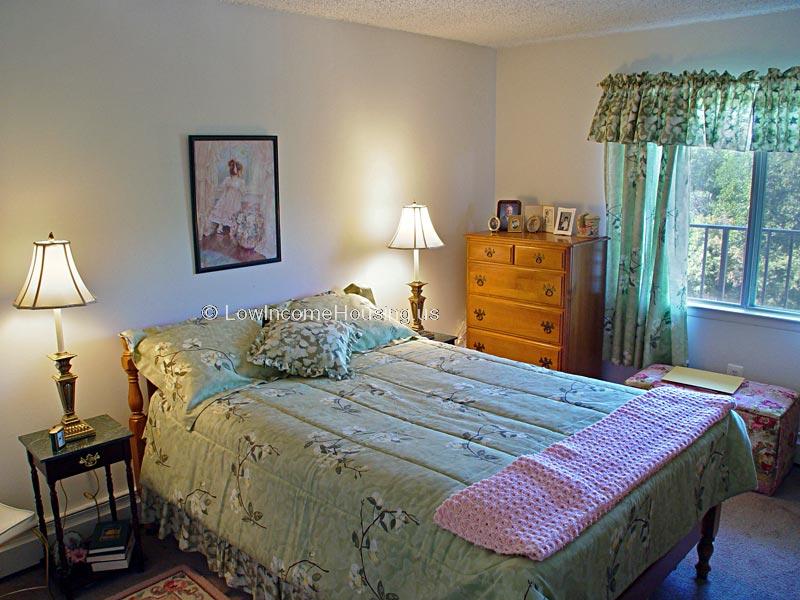 Spacious, well lit king size bedroom with large window and storage cabinet.  