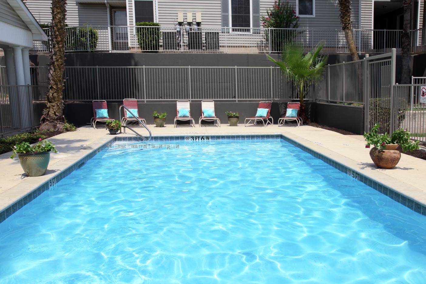 Wrought iron fencing to surround swimming pool.  Six lounge chairs for sunbathing.