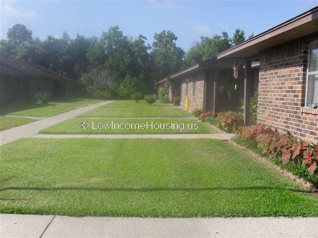 Classic red brick construction with manicured yards in front of single family housing units  