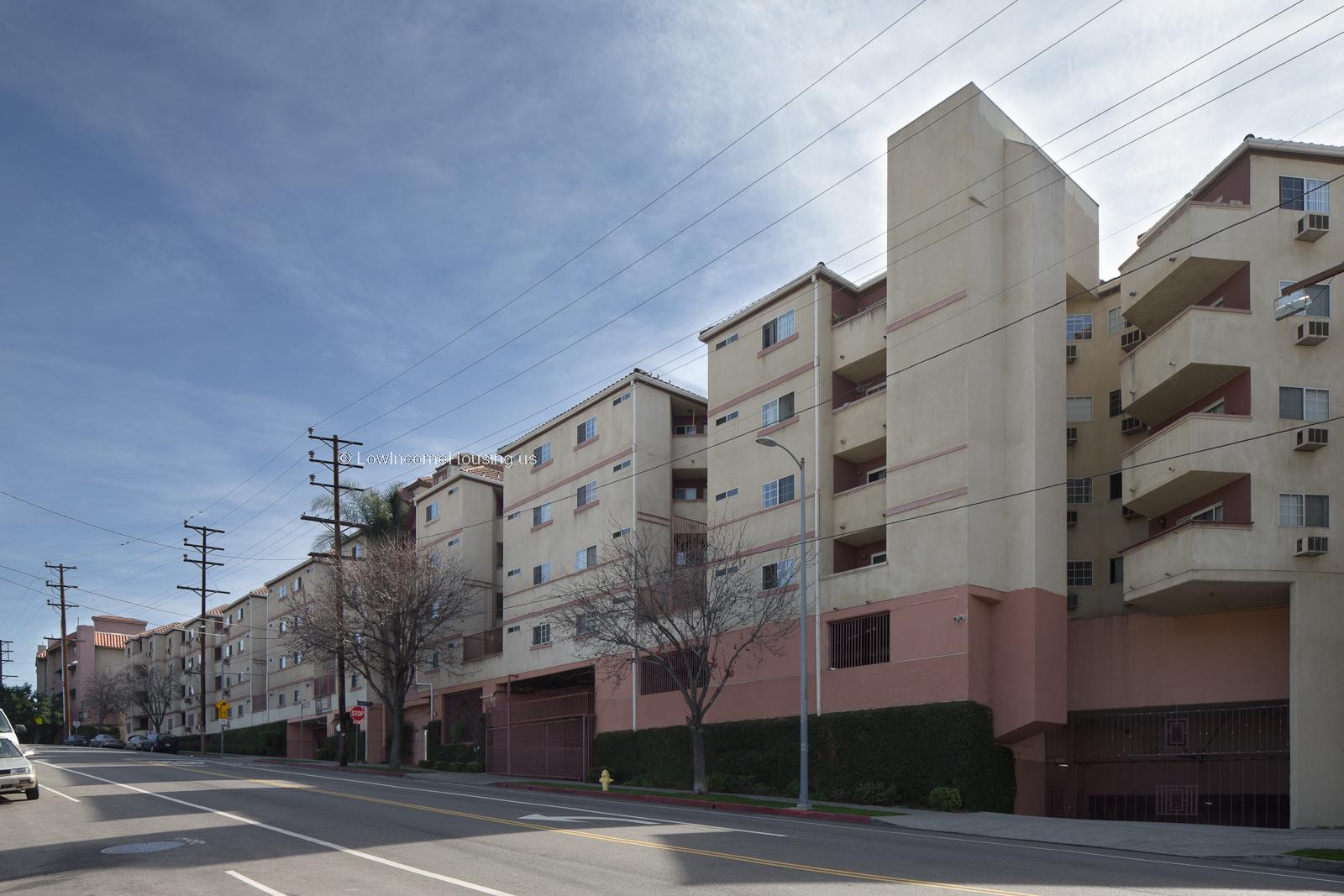 Classic white apartment buildings with balconies and air conditioning units installed