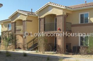 Two story residential building with balconies and staircase