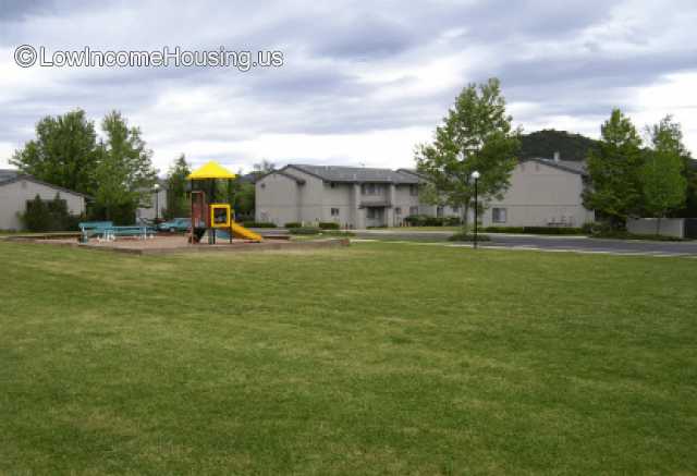 Appears to be a play ground as it has structures for climbing and sliding installed.  area appears to be enclosed by a brick wall.  There may be benches available.