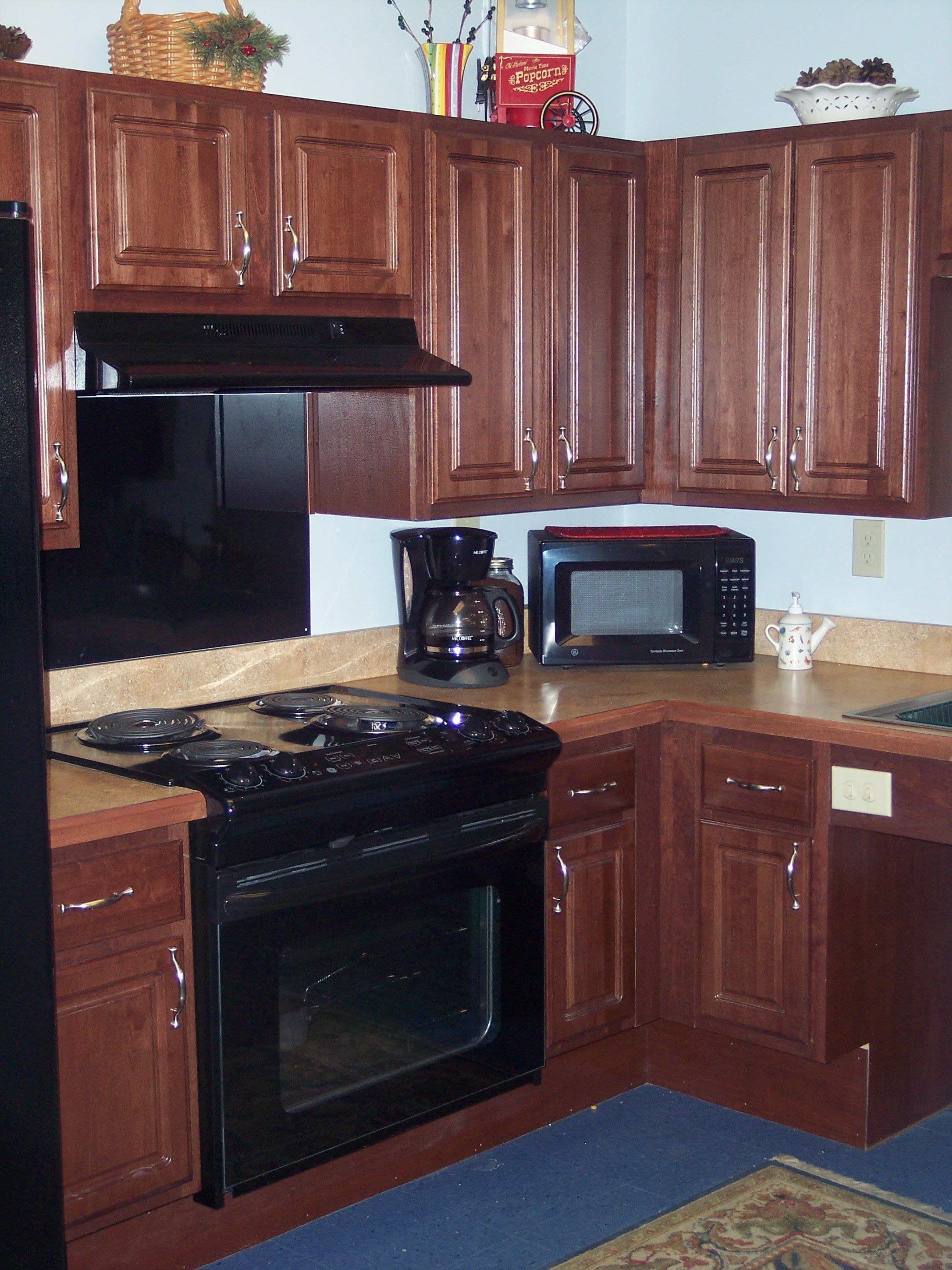 This is a photograph of an electric range which has an overhead light and exhaust fan.  