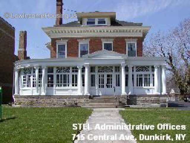 Administrative offices built with colonial motif, 9 Doric columns decorate the windowed facade, large red brick two story structure with 4 dormer windows are located on the second floor.   