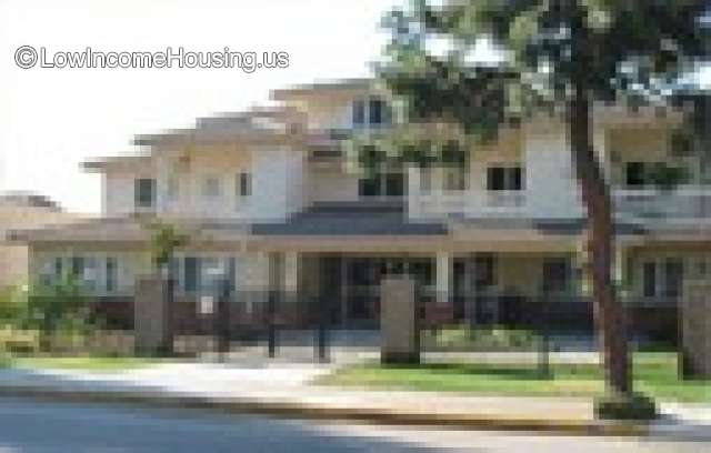 Town House apartment building consisting of 16 apartments constructed of wood siding painted white.