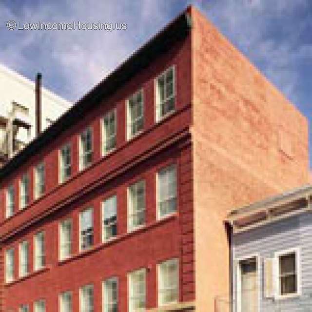 Corner picture of large, red brick 3 story building