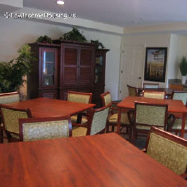 Large, spacious room filled with various card tables and chairs.