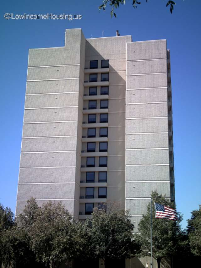 This is a concrete apartment block consisting of approximately 26  or more units serviced by an elevator.  