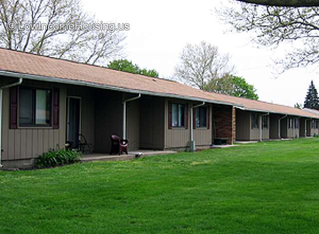 Red brick row housing with convenient porch space for evening relaxation. 