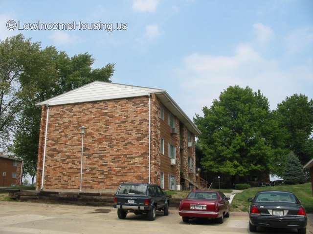 Large red brick housing unit consisting of approximately 12 living units. 