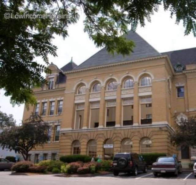 Large brick structure with large foundation under the larger building, the supported structure has 6 large columns and a large roof over the entire building