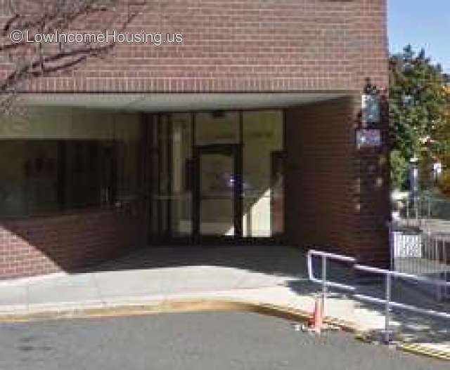 Entrance to brown  brick building with glass and steel frame  