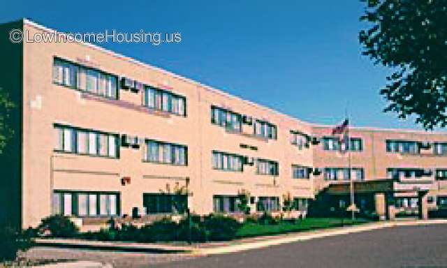 This is a photograph of Garden Terrace.  Large brick building with approximately 20 units.  The structure is three stories high and there appears to be ample parking space all though there are no cars