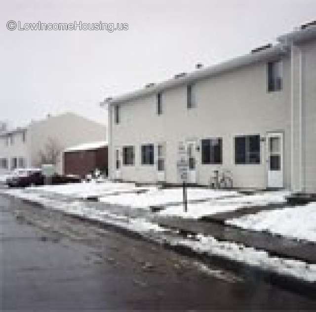 This is a photograph of a 4 door housing unit taken in the winter after a fairly heavy snowfall.  