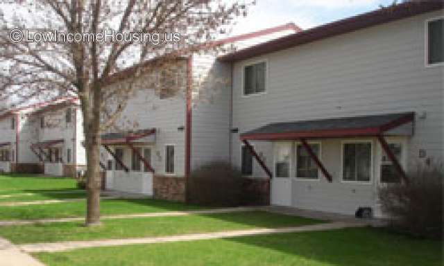 Photo of two units consisting of access door, windows, Awning over door, and windows.  Two units shown in photo. 