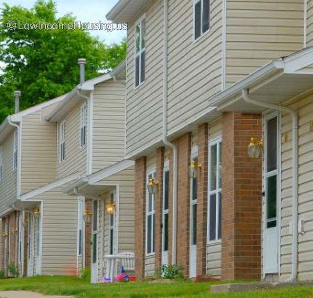 This is a photograph of two story, wooden structures which have been finished with wooden clapboard an painted white. 