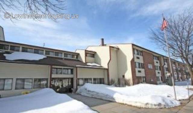 Classic red rick row house layout with three stories for rental units and a central administrative facility for  rental payments and other matters.