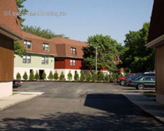 Three row house structures with dormer roofing.  