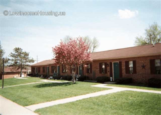 Simple row houses built with red brick.  Roofing is simple wooden framing with simple roofing materials applied.