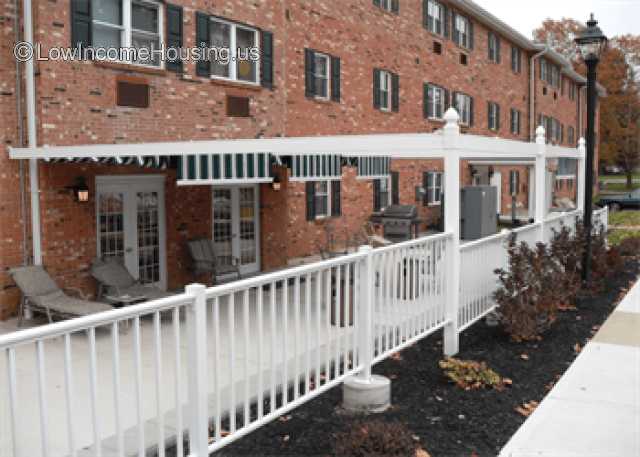 Red brick row houses with supports for awning 