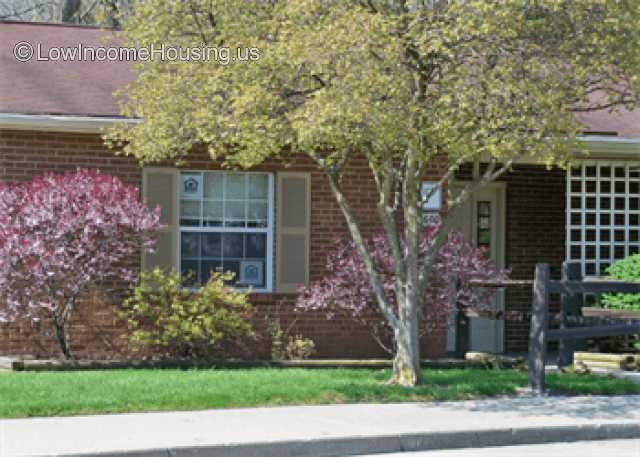 Simple red brick siding with simple roofing installed over wooden framework.