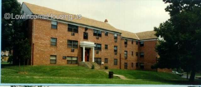 Classic red brick apartment building with 4 apartments per floor, air conditioning units installed for each apartment.