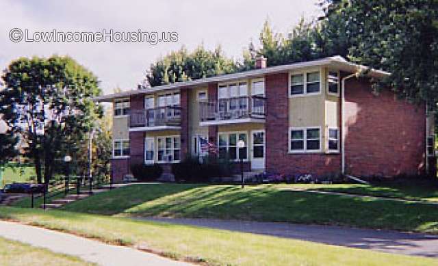 Tastefully appointed row housing with large, ground floor dormer windows and second floor balconies. 