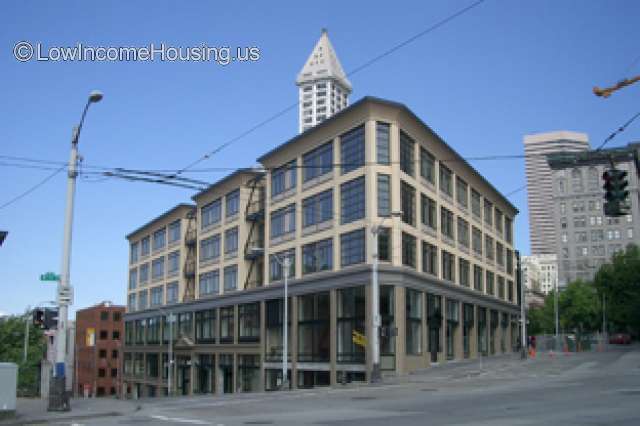 Corner Picture of industrial style office building, external stairways. Similar building in background.   