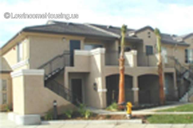 Duplex style apartment complex with external stairway to second story living area.  