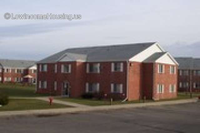 This is a photograph of the Cornell Apartments.  Three large two story buildings can be seen. Each building contains two floors and there are 5 large windows on each floor 